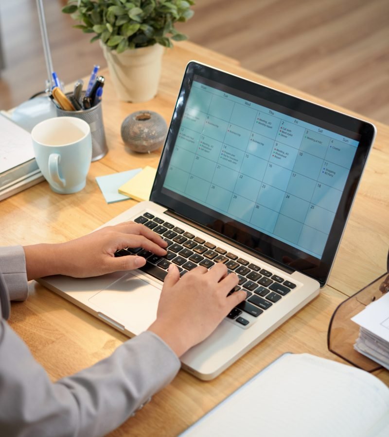 Business woman making schedule for the month